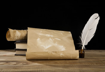 old paper, books and feather