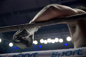 Detail of boxer's hand on the rope after the true fight
