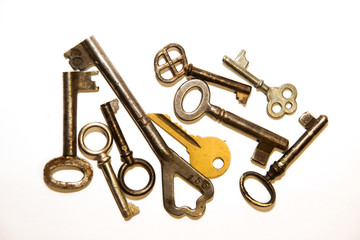 Many old keys to the safe on a white background