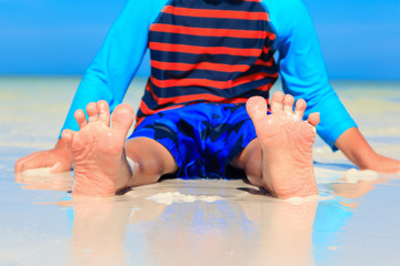 child feet on summer sand beach
