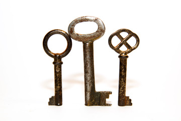 Three old keys to the safe on a white background