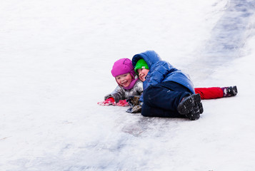 Fototapeta na wymiar Children riding the hills in winter