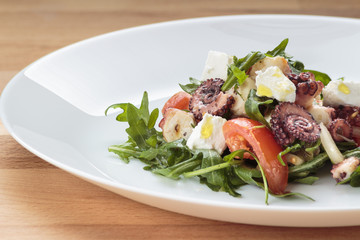 Octopus salad with rucola, olives and feta cheese