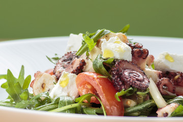 Octopus salad with rucola, olives and feta cheese