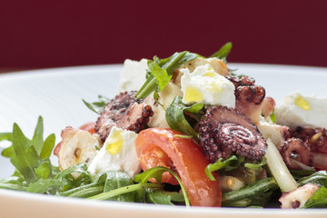 Octopus salad with rucola, olives and feta cheese