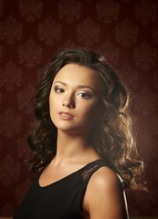 Fototapeta premium Beautiful young woman with long curly hair