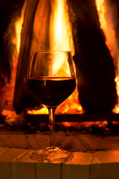 Glass Of Red Vine Near Fireplace