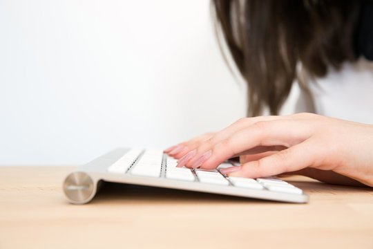 Closeup image of a female hands using keyboard