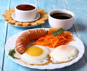 Breakfast fried scrambled eggs with sausage and carrots