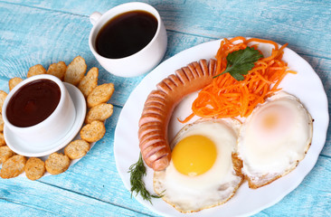 Breakfast fried scrambled eggs with sausage and carrots