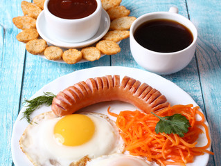 Breakfast fried scrambled eggs with sausage and carrots