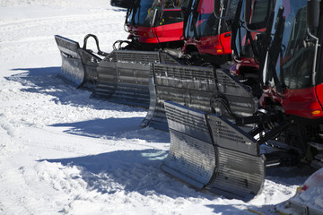 Group of Snow-grooming machine on snow hill ready for skiing slo