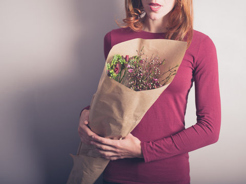 Young woman with bouquet of flowers