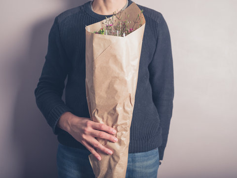 Young man with bouquet of flowers