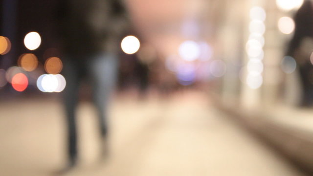 People walking in city night background.