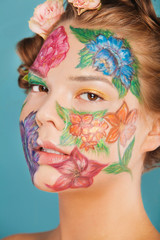 Close up portrait of woman model with hand drawing flowers on