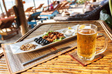 Squid tempura snack on plate on bamboo table