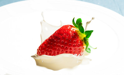 strawberry splashing on cream
