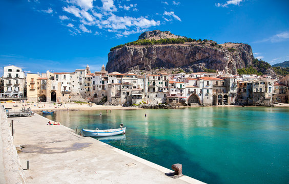 Beautiful old harbor with wooden fishing boat in Cefalu, Sicily