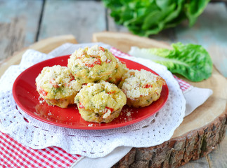 zucchini muffins with red pepper on a wooden background