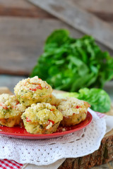 zucchini muffins with red pepper on a wooden background