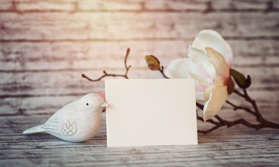 Bird Figurine with Card and Blossoms in Warm Light