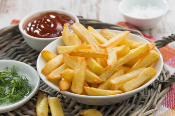 fried french fries with tomato sauce and herbs