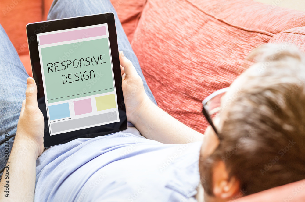 Poster hipster on the sofa with responsive design tablet