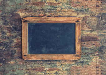 Antique chalkboard on wooden texture. Nostalgic background