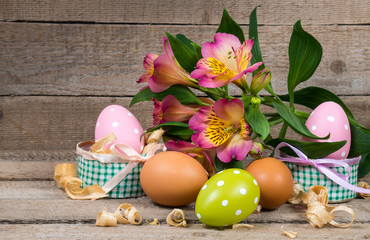 Obraz na płótnie Canvas Easter eggs in a pot and flower