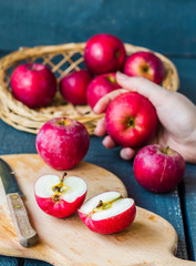 cut in half fresh red apples on a wooden board, fruits