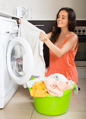 Girl using washing machine at home