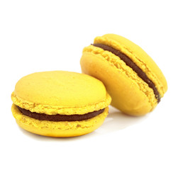 close up of colorful macarons over white background