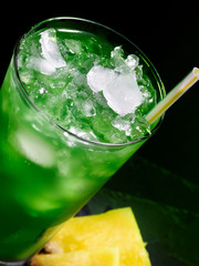 Green cocktail  on dark background.