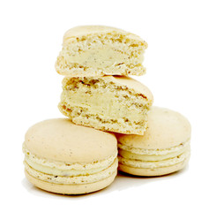 close up of colorful macarons over white background
