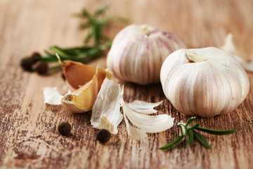 Raw garlic and spices on wooden table