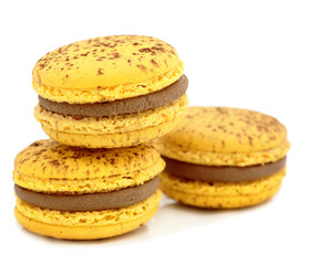 close up of colorful macarons over white background