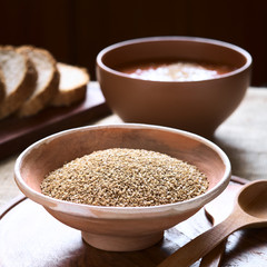 Obraz na płótnie Canvas Sesame seeds in bowl with vegetable cream soup in back