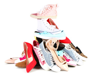 Pile of various female shoes isolated on white
