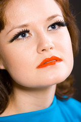girl in a blue dress with long eyelashes.