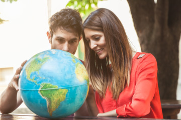 Fototapeta premium Young couple looks the world map