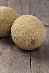 Fresh melons on old wooden background. Selective focus.