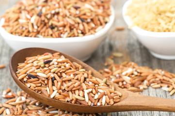 Brown rice with wooden spoon