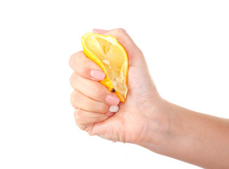 Female hand squeezing lemon isolated on white
