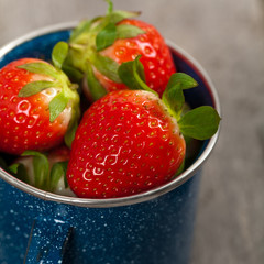 Strawberries on old wooden background. Selective focus.
