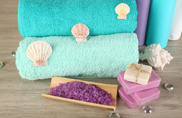 Obraz na płótnie Canvas Spa composition with towels and sea salt on wooden background