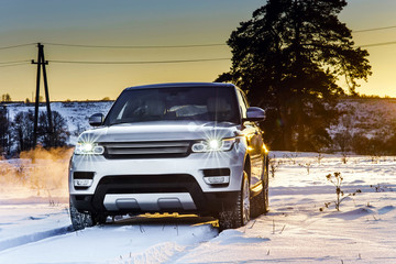 Powerful offroader car view on winter background