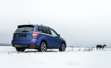 Fototapeta na wymiar Powerful offroader car view on winter background