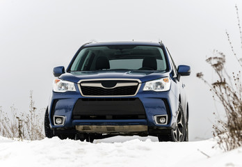 Fototapeta premium Powerful offroader car view on winter background