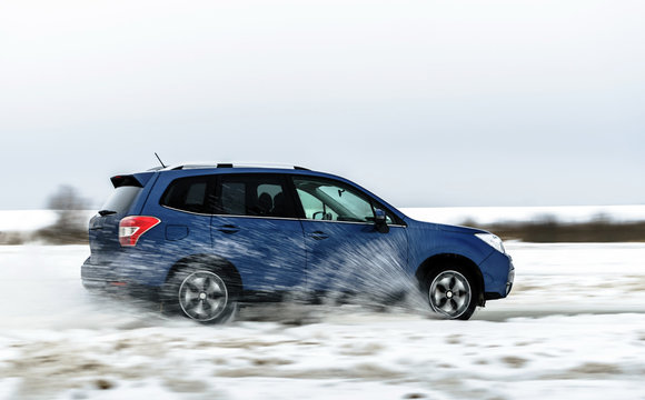 Powerful offroader car sliding by lake ice